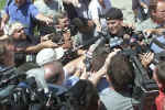 Tom Brady, upper right, New England Patriots quarterback and Super Bowl MVP, is surrounded by the media prior to a team meeting at Bryant College in Smithfield, R.I., Friday, July 26, 2002, as the Patriots began their first day of full training camp. (Photo/Stew Milne) 