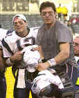 Tom Brady (left) and Drew Bledsoe prepare for the AFC Championship ceremony. And right now, nobody's saying which one of them will start the Super Bowl. (FOXSports)