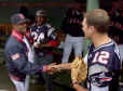 Tom Brady (R), quarterback of the Superbowl Champion New England Patriots, wishes Boston Red Sox ace pitcher Pedro Martinez (L) luck in the Red Sox dugout before the start of the Red Sox Opening Day game against the Toronto Blue Jays April 1, 2002 at Fenway Park in Boston. Patriots cornerback Ty Law (24) waits for an autograph from Martinez after the Patriots all threw out ceremonial pitches to start the game. REUTERS/Jim Bourg 