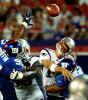 New England Patriots quarterback Tom Brady throws an incomplete pass as he is hit by New York Giants linebacker Dhani Jones, right, as Patriots right guard Damien Woody blocks Giants Cornelius Griffin, left, during the first quarter Saturday night, Aug. 10, 2002, at Giants Stadium in East Rutherford, N.J. (AP Photo/Bill Kostroun) 