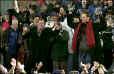 New England Patriots quarterback Tom Brady, right, wearing red scarf, dances with head coach Bill Belichick, center, in plaid scarf, during a Super Bowl celebration on City Hall Plaza. At far left on stage is Patriots owner Robert Kraft. (BostonHerald)