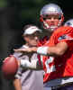 New England Patriots quarterback Tom Brady works on passing drills as coach Bill Belichick, background, looks on during the afternoon practice at Bryant College on Wednesday, Aug. 7, 2002, in Smithfield, R.I. (AP Photo/Victoria Arocho) 