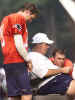 New England Patriots offensive coordinator Charlie Weis, center, talks with quarterback Tom Brady, right, as fellow quarterback Damon Huard, left, looks on during Patriots training camp at Bryant College Wednesday, Aug. 14, 2002 in Smithfield, R.I. (AP Photo/Victoria Arocho) 